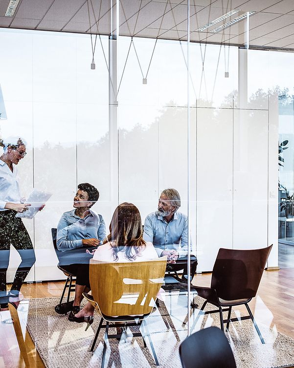 Four people in a meeting room.