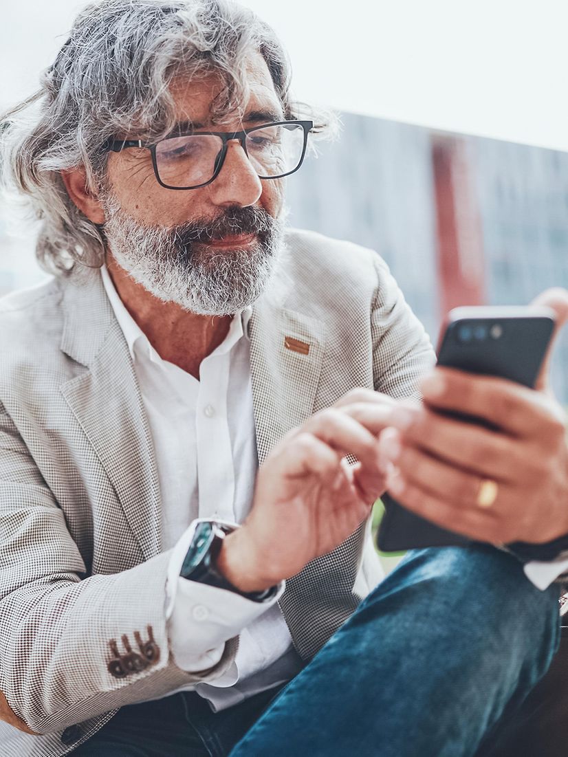 A man looks at his mobile phone.