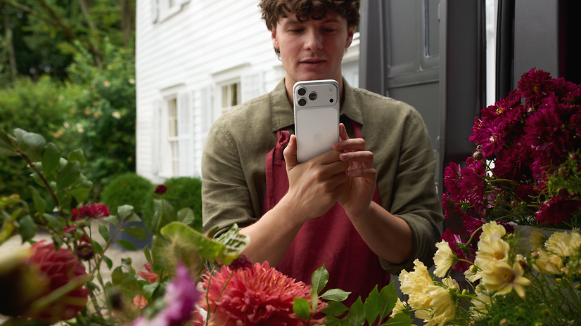 Florist photographs his flowers for customers with an iPhone 17 Pro.