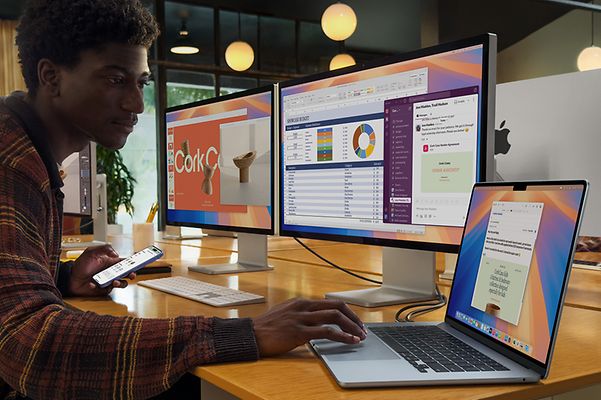 Man is in the office using a MacBook