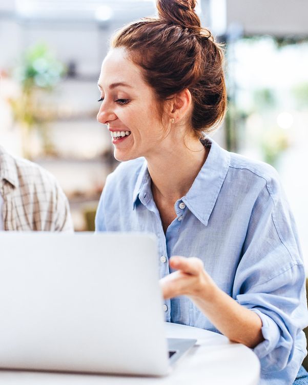 New employee sits in front of her MacBook, which is immediately ready for use.