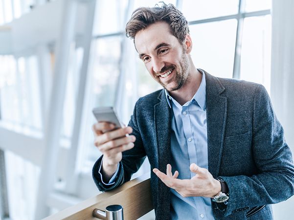 A man looks at his mobile phone.