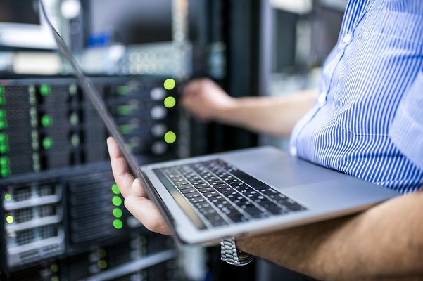 Man with laptop sets up services on Business Premium Access.