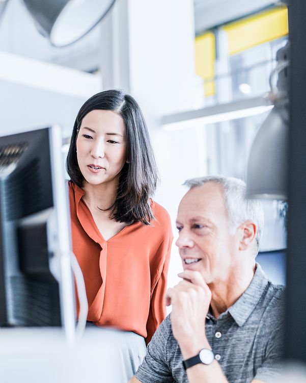Office staff examine the contact management feature of the Gigaset N670 DECT.