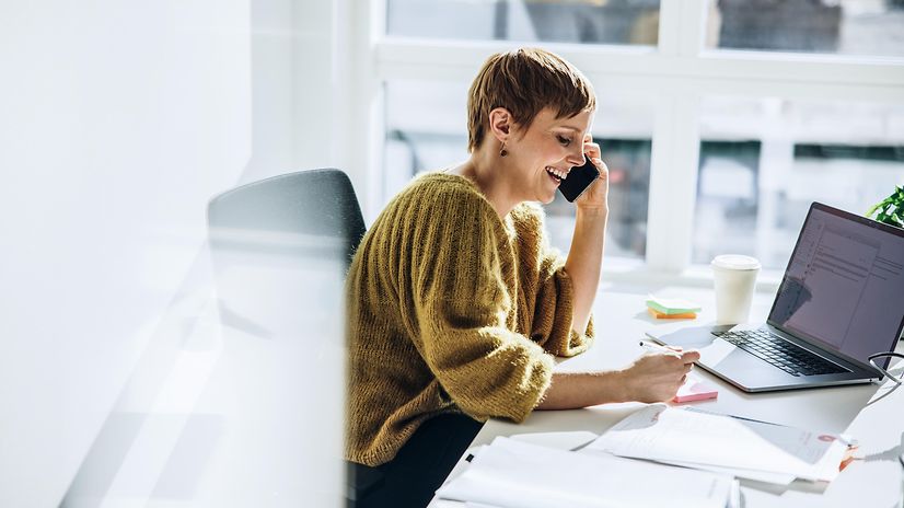 Woman talking on a telephone for CloudPBX systems
