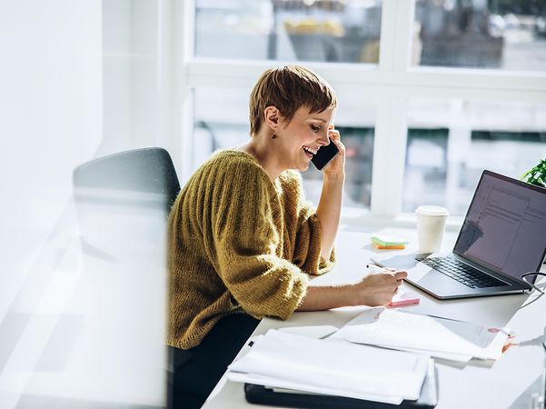 Woman talking on a telephone for CloudPBX systems