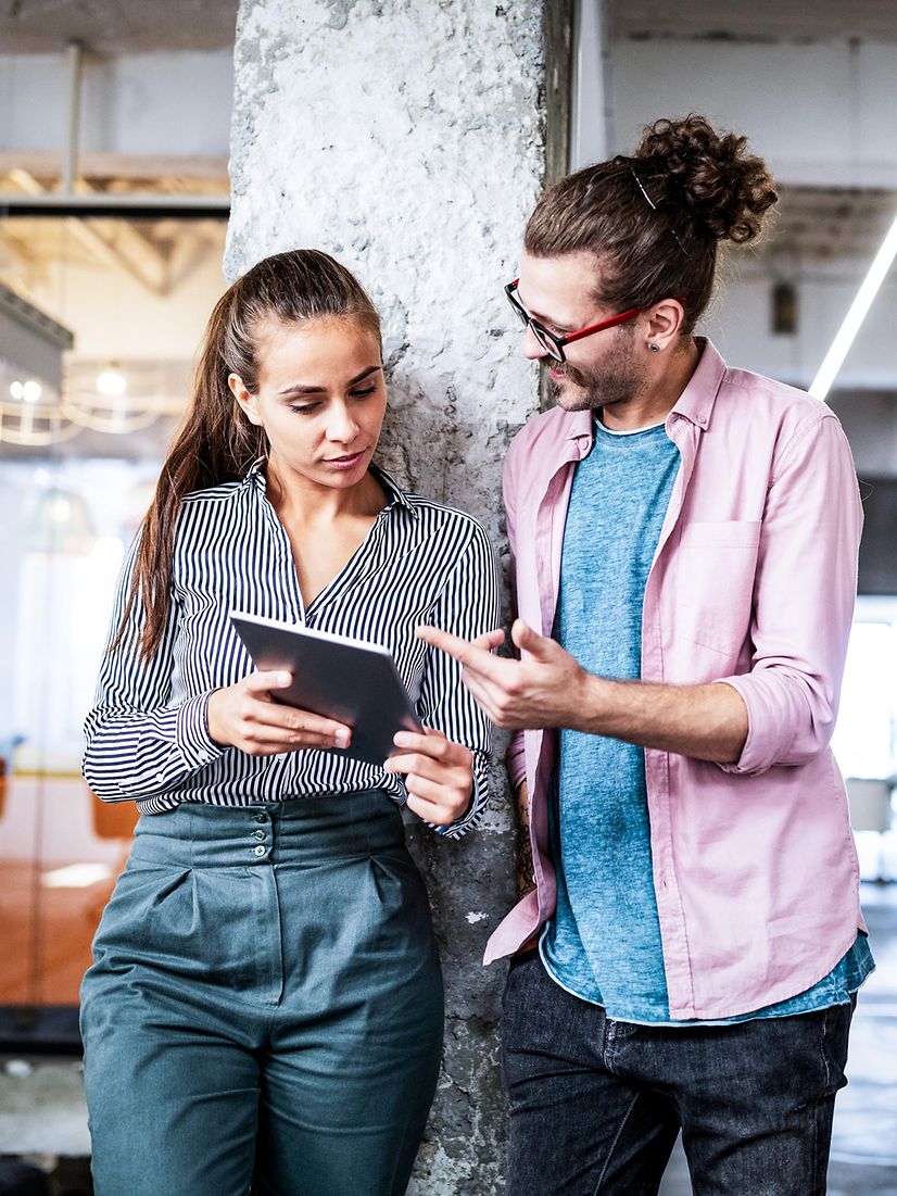 Two company founders are testing Telekom's Homepage Designer on a tablet using the non-binding demo version.