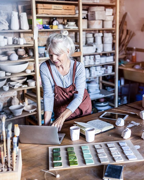An artist checks the search engine rankings of her studio, optimised with Local Listing, on her laptop.