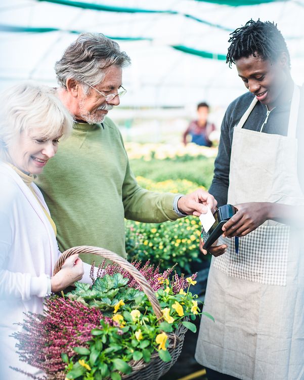 An elderly couple happily shops at the vegetable stall they found thanks to good online reviews.