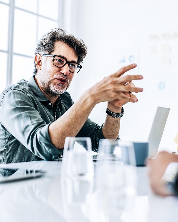 Executive at a business meeting expresses her T Business conviction