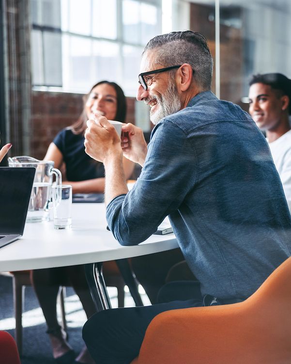 Collegial team meeting with a focus on T Business Partnership in a modern conference room