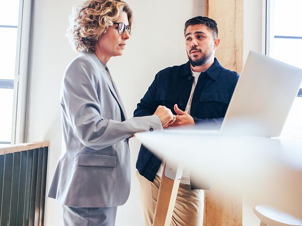 Two business people talking about business partnership in an office
