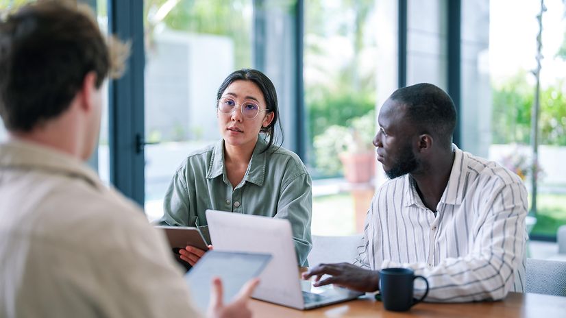 Multicultural team participates in strategy meeting using digital tools