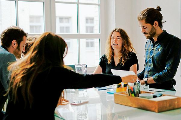 Young team sits together and discusses the new partnership
