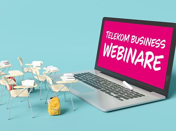 Laptop with "Telekom Business Webinars" lettering and miniature chairs – symbolising digital knowledge transfer