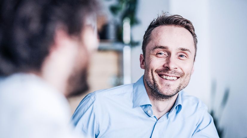 A man smiles because his broadband connection is equipped with fail-safe protection.