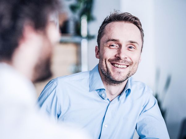A man smiles because his broadband connection is equipped with fail-safe protection.