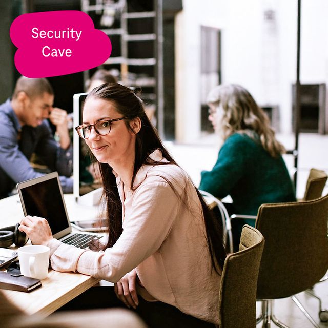 Image shows a group of people working in an open-plan office