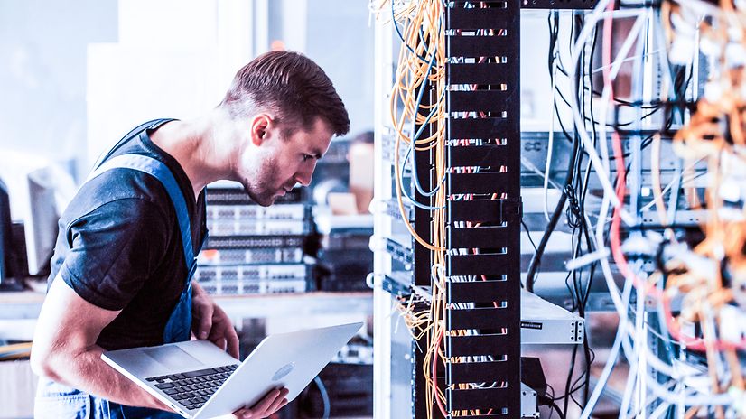 A man checks several cables.