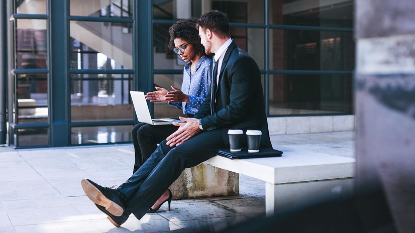 Woman with laptop explains something to man about funding for digitalisation