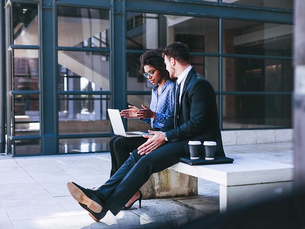 Woman with laptop explains something to man about funding for digitalisation