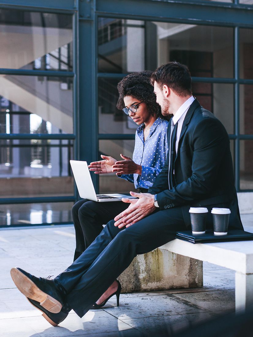 Woman with laptop explains something to man about funding for digitalisation