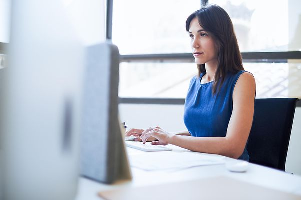 Woman sitting at a computer in an office