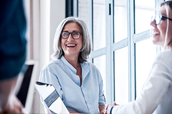 A middle-aged woman and a young colleague during a meeting
