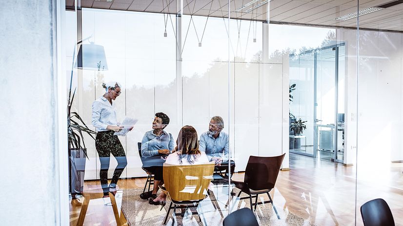 4 business people in a meeting room
