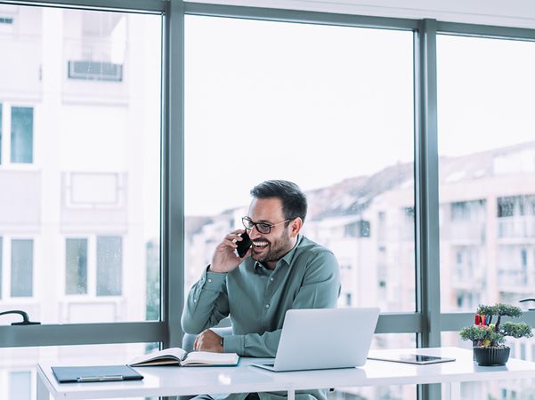 A man is on the phone, enquiring about Magenta Secure SASE Ecoplay Fortinet
