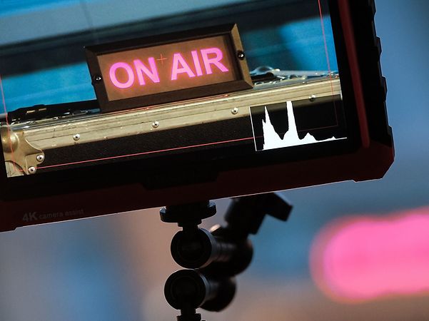 RTL camera screen with black frame and magenta lettering on air