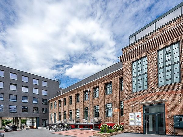 Red brick building with modern extension is the headquarters of Hitzler Engineers.