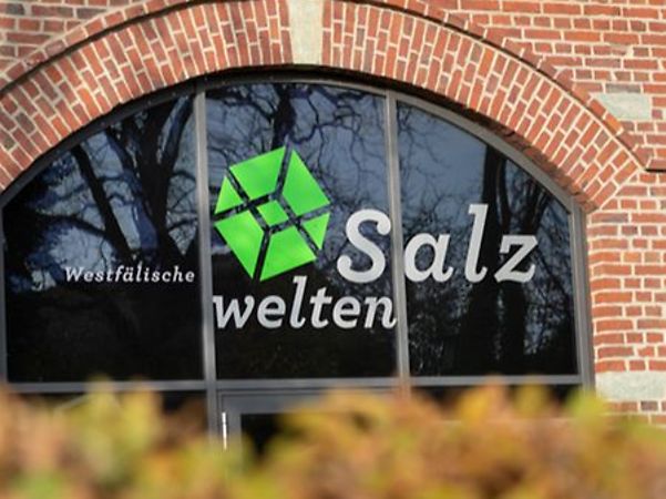 Red brick building with arched windows and Westfälische Salzwelten logo