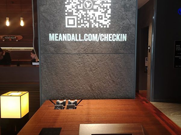 Contactless check-in counter in grey and brown in a lobby of Lindner Hotels