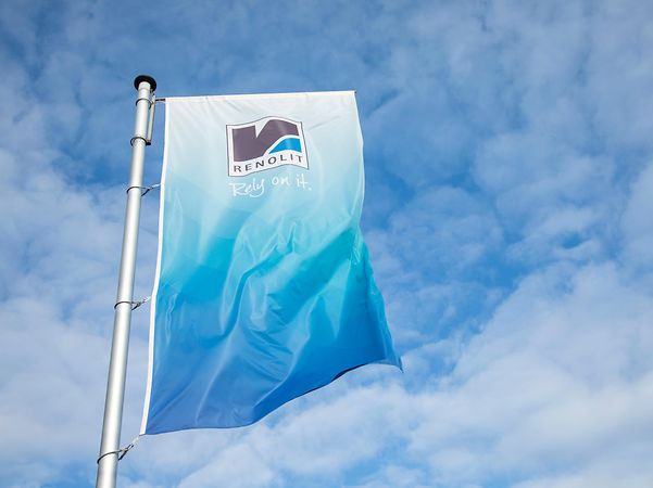 Blue and white company flag with RENOLIT lettering flies from the flagpole