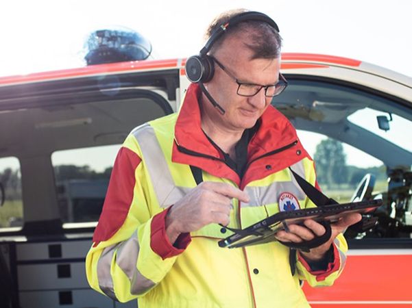 Emergency doctor with headset and tablet for FTI Ambulance Video Assist