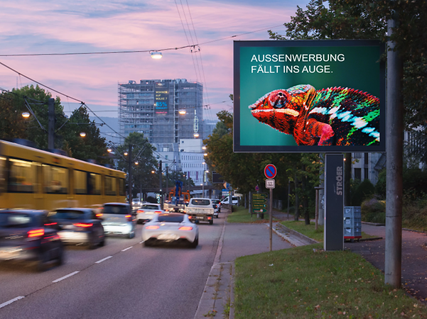 Image shows an illuminated Citylight on a busy main road in Stuttgart during the early evening hours.