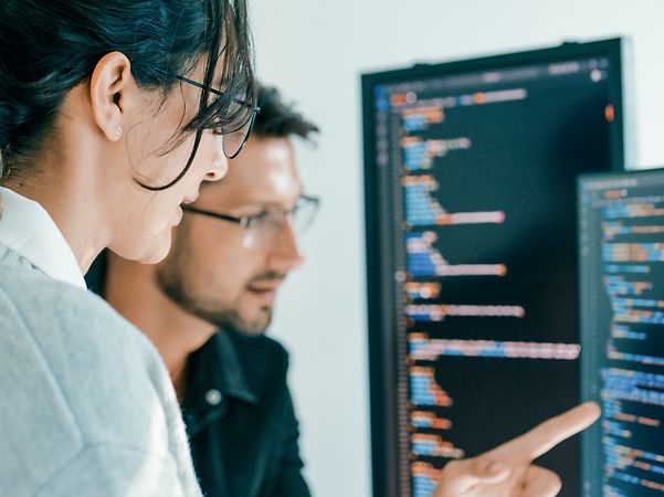 Colleagues look at data on the screen