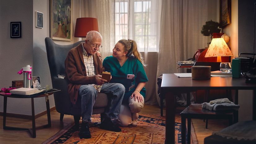 Caregiver looks after elderly gentlemen in a care facility