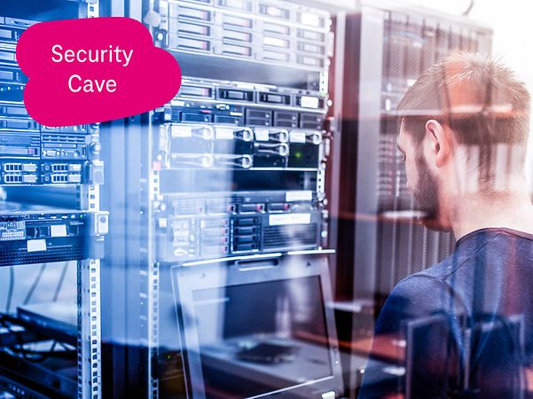 T-Administrator works on a pull-out laptop in front of a server cabinet in a data centre.
