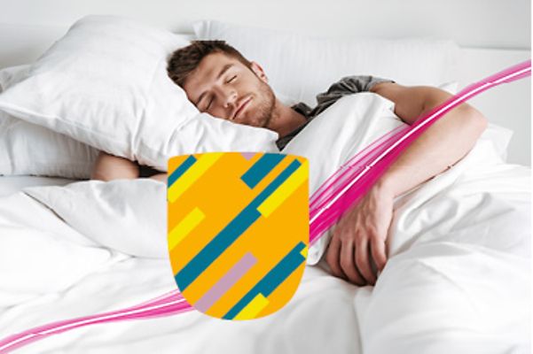 A man sleeping peacefully on white pillows, protected by a green and yellow security shield