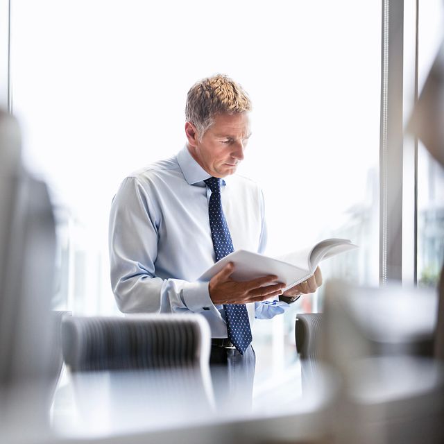 A man is reading something about Magenta Secure SASE in the office