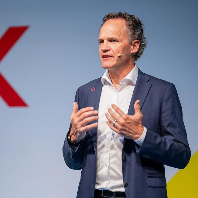 Lars Neumann with a microphone - square