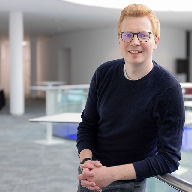 Portrait of Dr Niklas Horstmann in a brightly lit foyer
