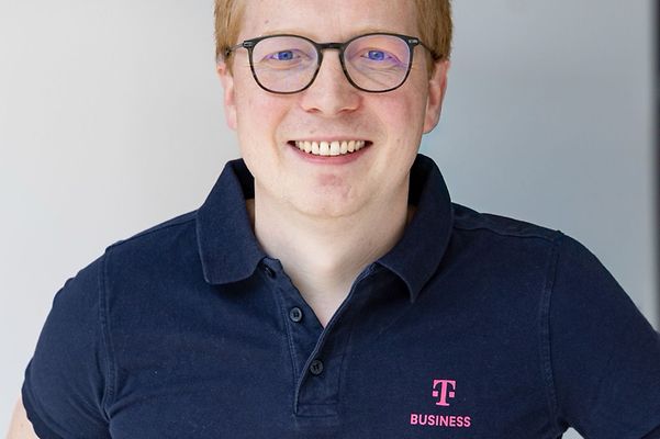 Portrait of Dr Niklas Horstmann wearing a blue T Business polo shirt