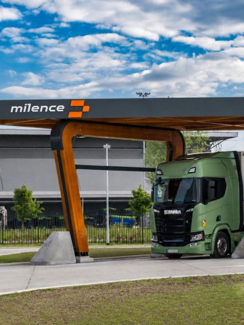 Milence lorry loading bay with a green and black lorry under the roof