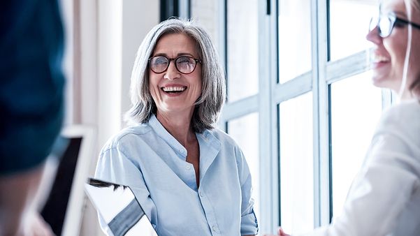 Eine Frau mittleren Alters und eine junge Mitarbeiterin während eines Meetings