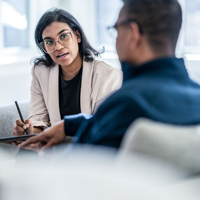 Kollegen unterhalten sich auf einem Sofa über Zoom X Whiteboards