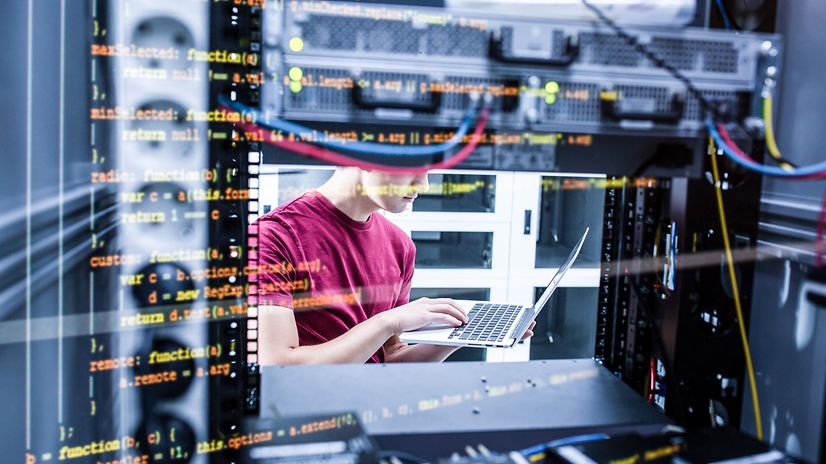 Ein Mann arbeitet vor einer Datenbank an seinem Laptop.